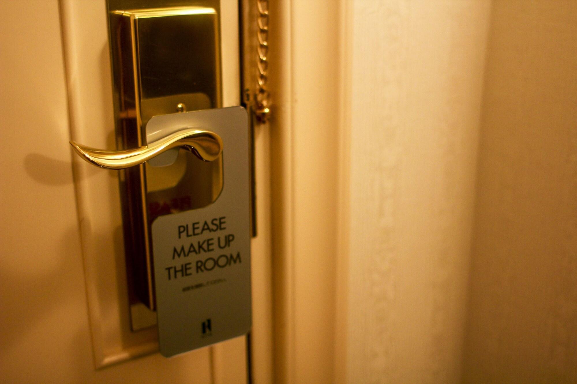 Royton Sapporo Hotel Eksteriør bilde A door sign requesting a maid service